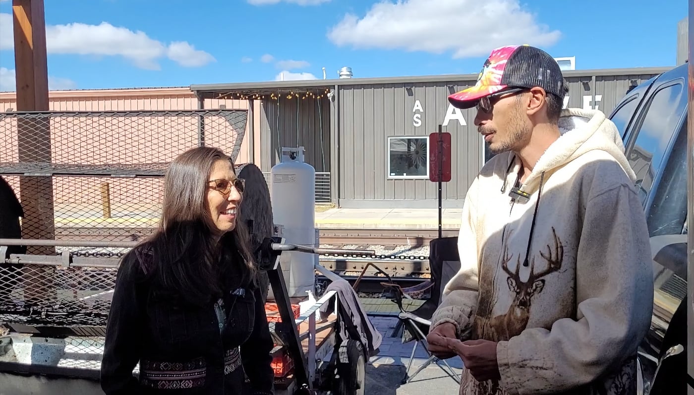 Representative Teresa Leger Farnández talking with the Santa Fe Farmer's Market Institute