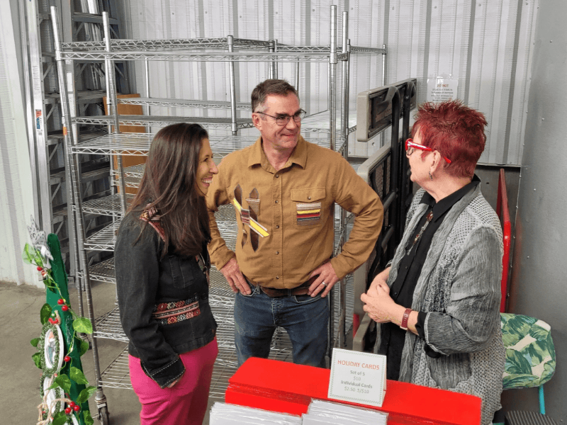 Representative Teresa Leger Fernández talking with Santa Fe Farmers' Market Institute staff.
